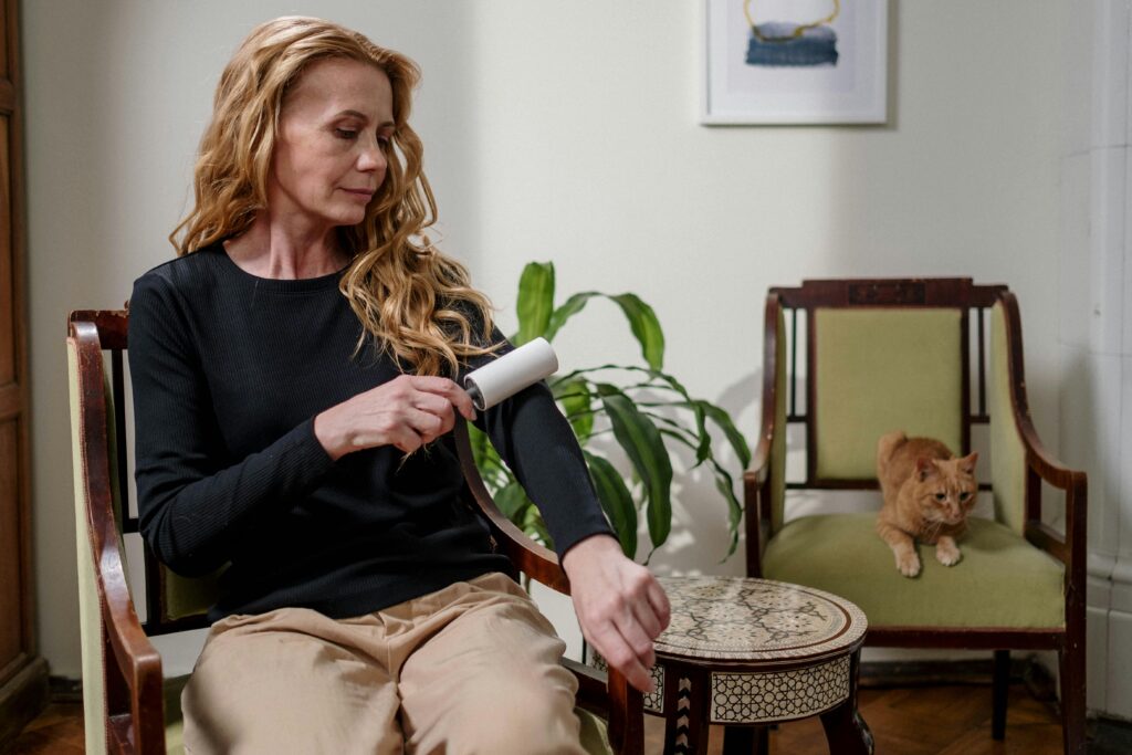 woman cleaning up cat hair